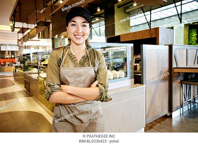 Portrait of smiling Mixed Race worker in food court