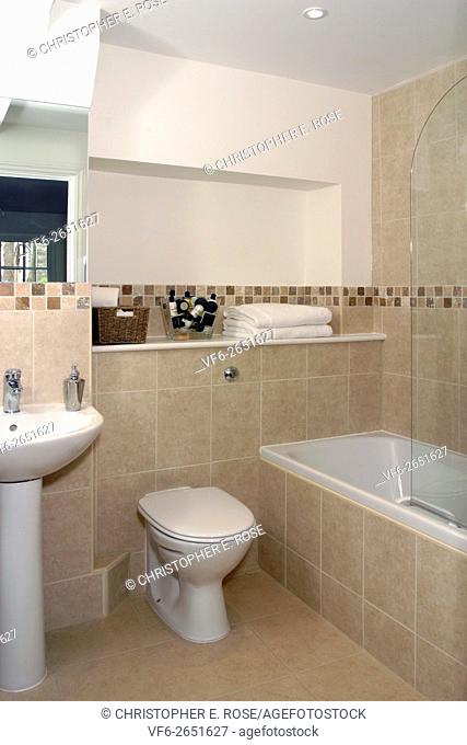 UK showhome interior, modern fitted tiled bathroom. For Editorial Use Only