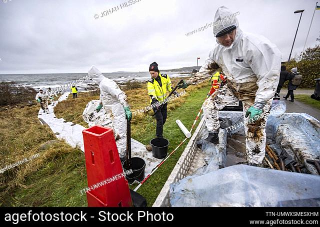 FILE PICTURE DATED 26 OCT, 2023. Personnel from the Coast Guard work on cleanup after the oil leak from the grounded ferry Marco Polo on the coast of Horvik