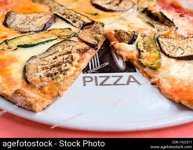 In the picture a whole wheat pizza with eggplant , zucchini , tomato and Neapolitan buffalo mozzarella.( Bufala campana)
