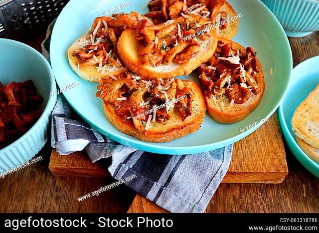 Chanterelle sandwiches with cheese. Open faced sandwich with creamy , seasonings and pepper and herbs on an old wooden background. Mock up. Top view