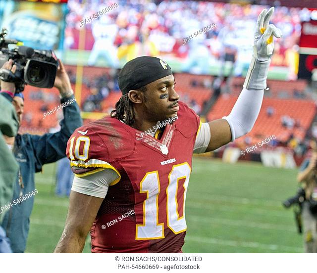 Washington Redskins quarterback Robert Griffin III (10) acknowledges his fans as he leaves the field following the game against the Dallas Cowboys at FedEx...