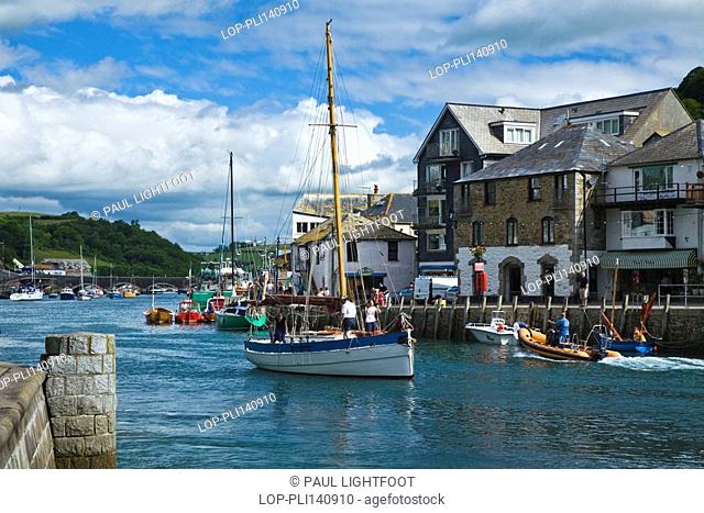 England, Cornwall, Looe, A traditional fishing lugger passes down the River Looe