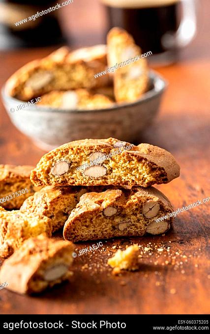 Italian cantuccini cookies. Sweet dried biscuits with almonds on wooden table