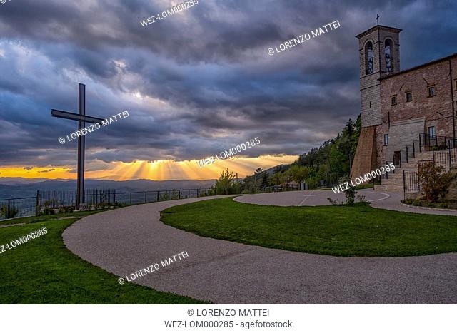 Italy, Umbria, Apennines, Gubbio, Cross and Church of Saint Ubaldo at sunset