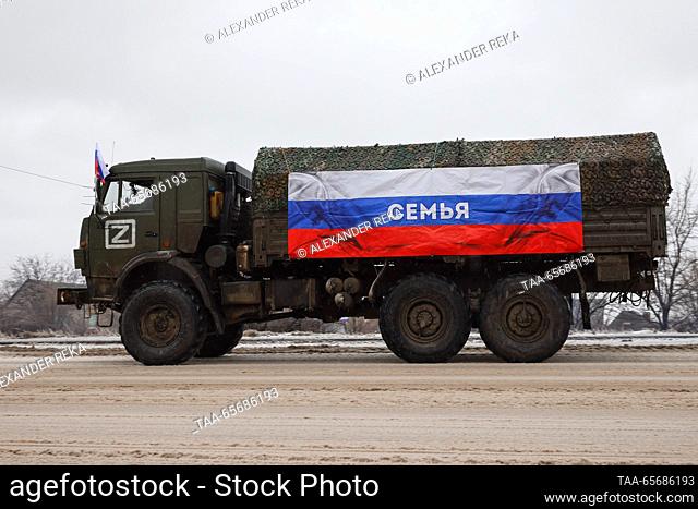 RUSSIA, LUGANSK - DECEMBER 12, 2023: A truck flies a Russian flag signed ""Family, "" more than 20 pieces of special equipment and other supplies collected by...