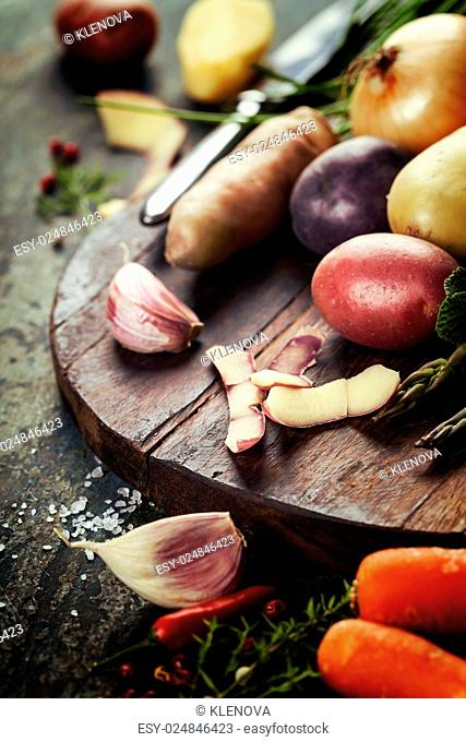 Raw colorful potatoes and vegetables ready for cooking. Fresh organic vegetables. Food background. Healthy food from garden