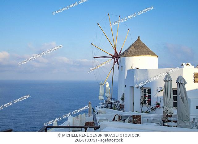 Sunrise with windmill in Oia, Santorini Greece
