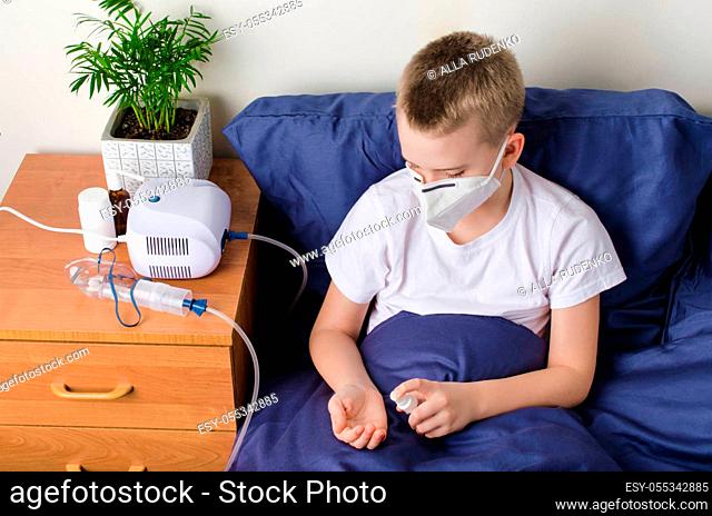 Sick boy in medical protective mask using hand sanitizer. Child sits on bed. Coronavirus Outbreak Concept