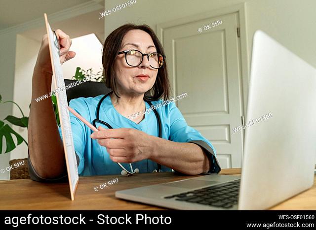 Doctor advising patient through video call on laptop at medical practice