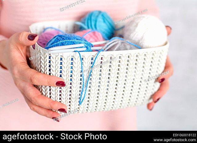 Knitting concept female hands with color clew ball