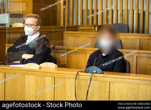 16 June 2021, Saarland, Saarbrücken: The defendant sits next to his lawyer Pascal Bastuck (l) in the courtroom of Saarbrücken Regional Court