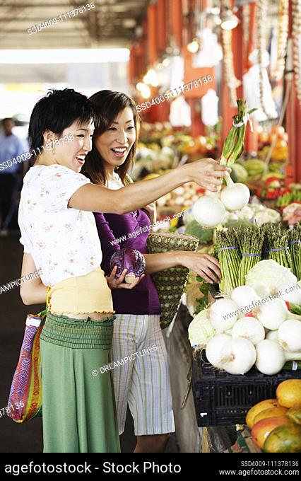 Two women shopping for produce