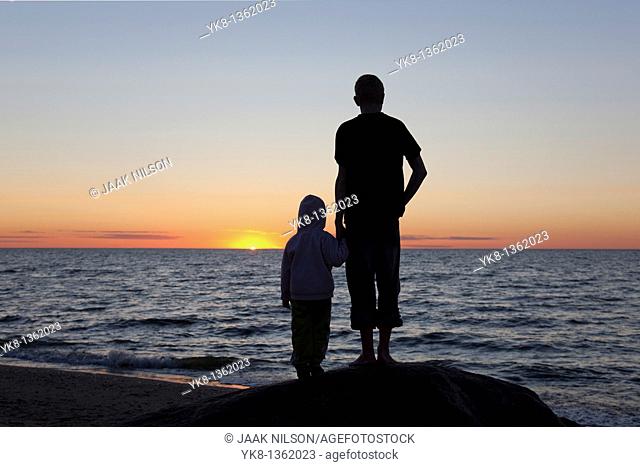 Kids Silhouettes at Sunset on Beach