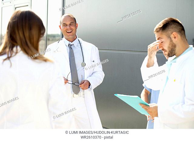Group of doctors talking outdoors