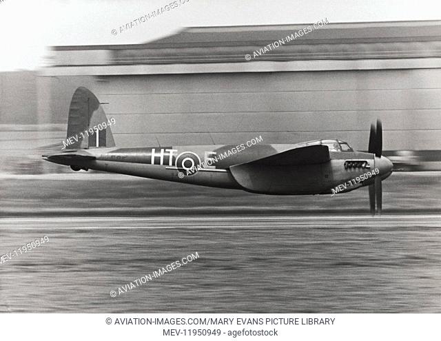 Royal Air Force RAF de Havilland Dh-98 Mosquito Low-Flying with Hangars Behind