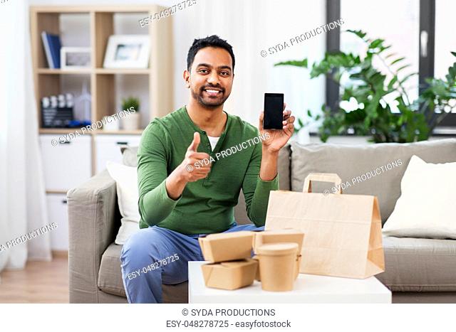 indian man using smartphone for food delivery