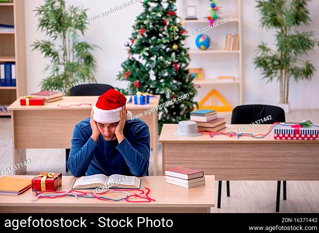 Young student preparing for exams during new year celebration