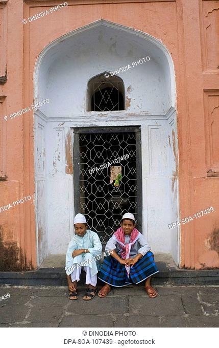 Muslim Boys Sitting at entrance of Lalbagh fort  built by prince Muhammad Azam ; Son of  Mughal emperor Aurangzeb in 1678 AD ; Dhaka ; Bangladesh