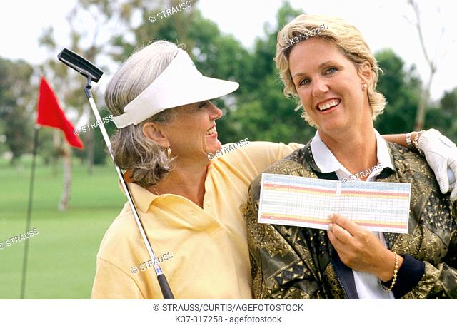 Golfing women showing their score cards