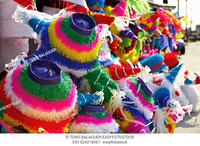 Mexican party pinatas decorated with fringed tissue colorful paper