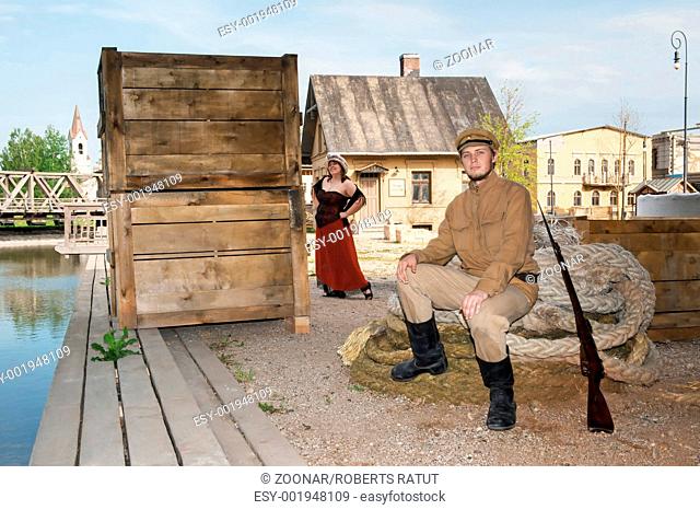 Lady and soldier with gun in retro style picture
