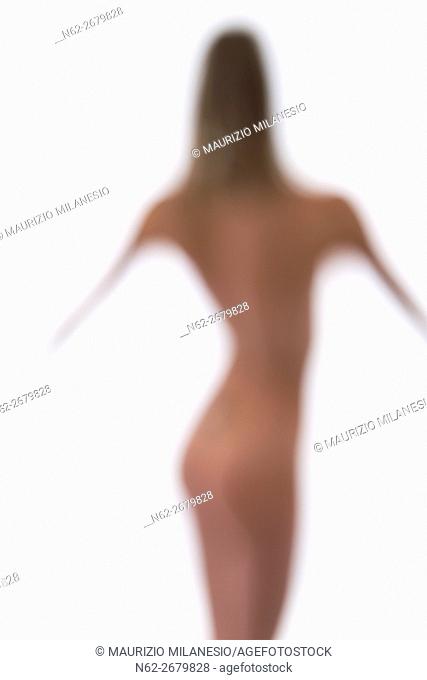 Blurred silhouette of a naked woman on a white backdrop
