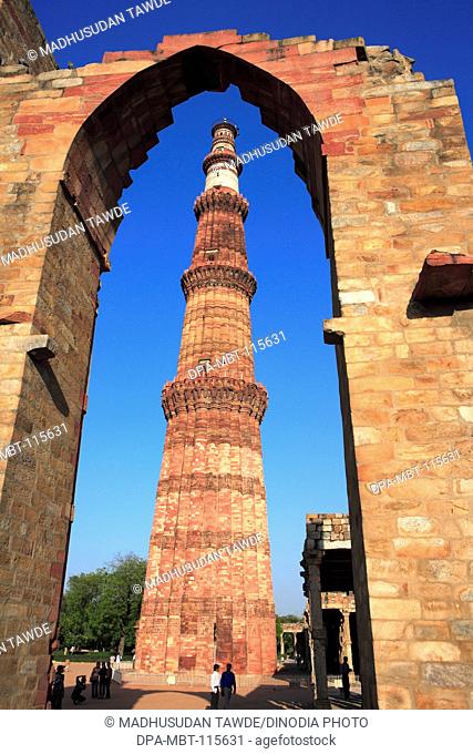 Qutb Minar through arch built in 1311 red sandstone tower , Indo-Muslim art , Delhi sultanate , Delhi, India UNESCO World Heritage Site