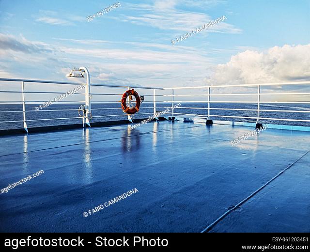 Blue picture of cruise ship deck and ocean with beautiful sky - concept of ferry transport and holiday vacation season