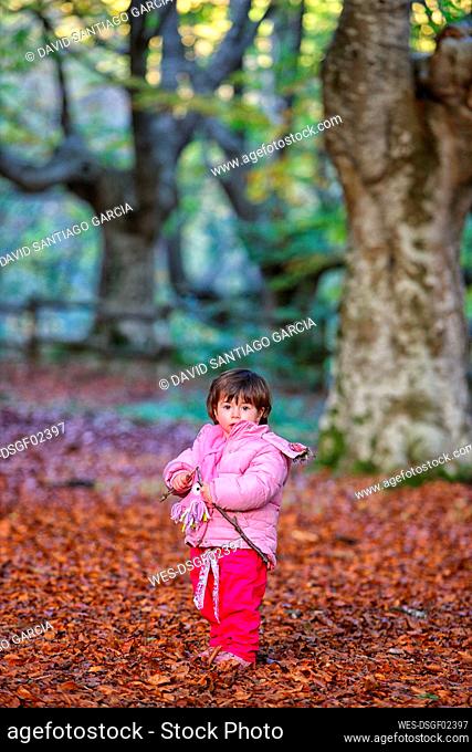 Girl standing on autumn leaves in Gorbea Natural Park
