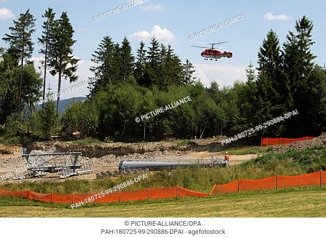 25 July 2018, Willingen, Germany: Parts of a chairlift support of the new 8-seater chairlift ""K1 Willingen"" on the Köhlerhagen runway lie on the slope