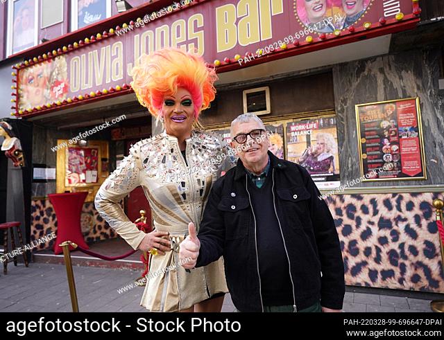 22 March 2022, Hamburg: Pastor Karl Schultz and drag queen and entrepreneur Olivia Jones stand in front of the ""Olivia Jones Bar"" not far from the St
