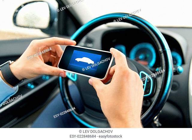 transport, business trip, technology and people concept - close up of male hands with car icon on smartphone screen in car