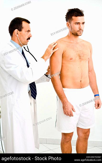 Doctor examining young male patient