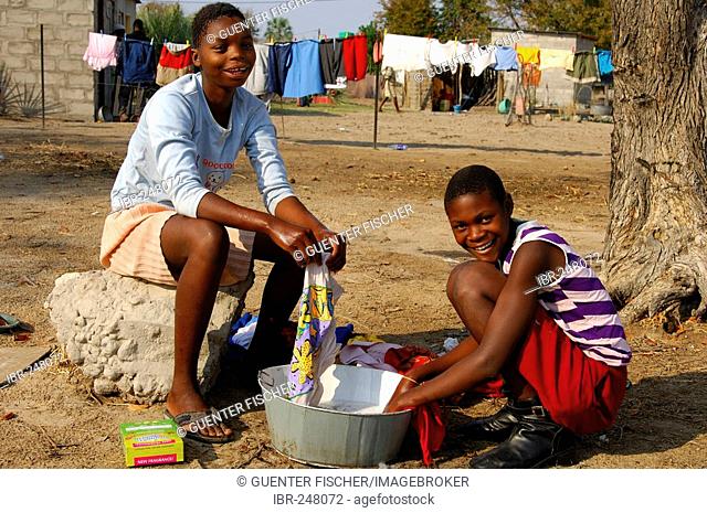 Young girls doing the laundry, Maun, Botswana