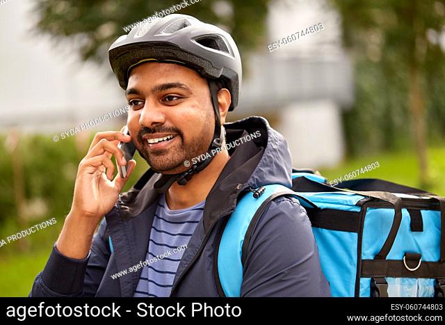food delivery man with bag calling on smartphone