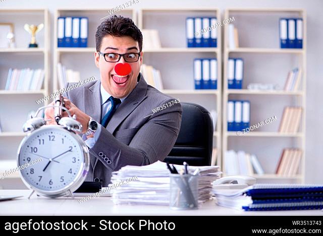 Clown businessman working in the office angry frustrated with a gun