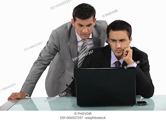 Business associates reading a distressing e-mail
