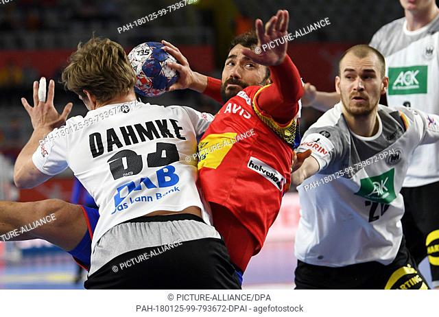 Spain's Daniel Sarmiento (C) overcoming the defence by Germany's Rune Dahmke (L) and Maximilian Janke during the European Men's Handball Championship match...