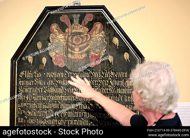 14 July 2021, Mecklenburg-Western Pomerania, Güstrow: Susanne Buch, restorer, presents the restored epitaph for Johann Cothmann (born 1588 in Lemgo