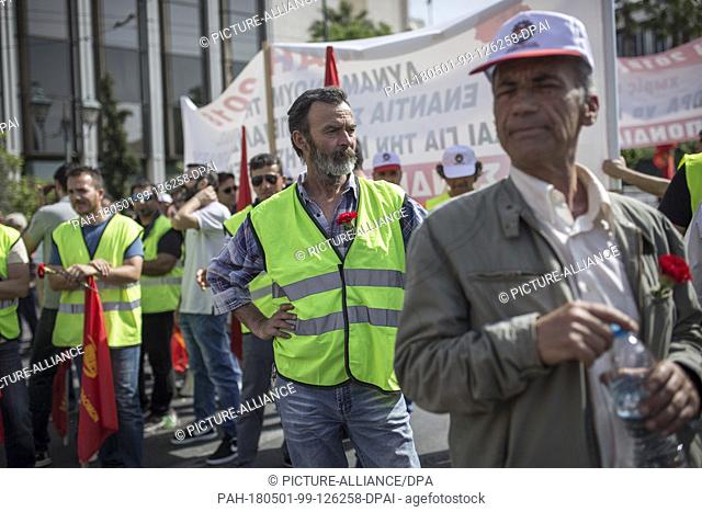 01 May 2018, Greece, Athens: Members of the pro-communist union PAME take part in a May Day rally outside the Greek Parliament