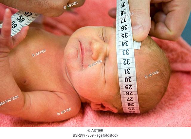 Photo essay at the maternity of Saint-Vincent de Paul hospital, Lille, France. Examination of the newborn baby girl one of the girl twins by the pediatrician on...