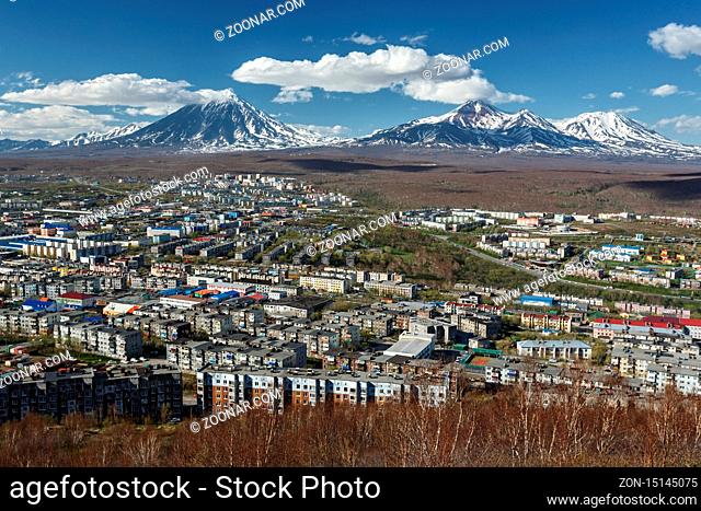 Panoramic view of the city Petropavlovsk-Kamchatsky and volcanoes: Koryaksky Volcano, Avacha Volcano, Kozelsky Volcano. Russian Far East, Kamchatka Peninsula