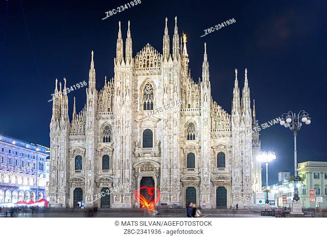 Duomo di Milano and a woman light paint a heat in Lombardy, Italy