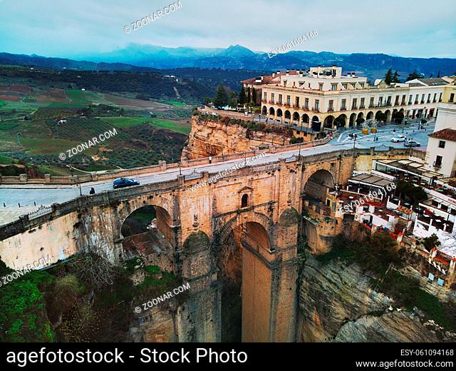 Aerial photography Ronda cityscape, residential houses buildings exterior rooftop, New bridge stunning canyons. Costa del Sol, Málaga, Spain