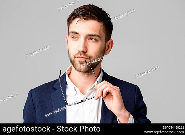 Business Concept - Portrait of a handsome businessman in suit with glasses serious thinking with stressful facial expression