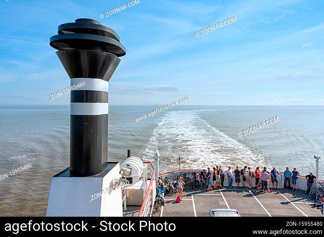 Hollum, The Netherlands- August 02, 2011: Passengers looking to wake at deck Ferry from Holwerd to Dutch island Ameland