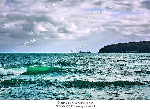 Waves on the Black Sea. Cargo Ship on Horizon