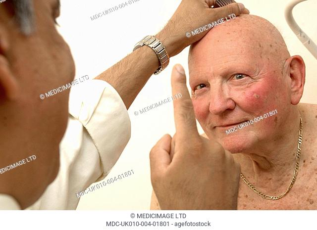 A GP performs the follow my finger eye test on an elderly male patient to check the eight fields of vision muscles, inferior, superior, lateral, medial, rectus