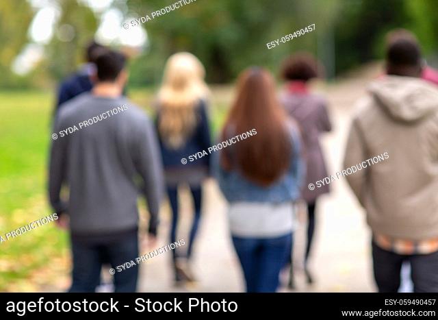 international group of people walking in park